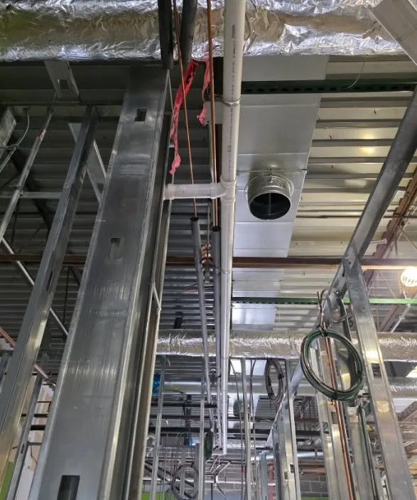Overhead plumbing coordinated with ductwork and framing