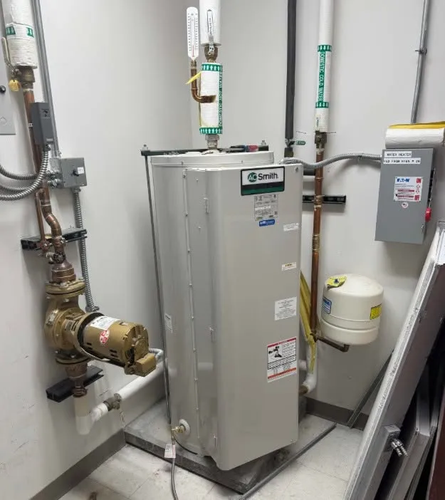 Commercial water heater with backflow preventer and expansion tank